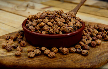 Tiger nuts in a ceramic bowl on a wooden table