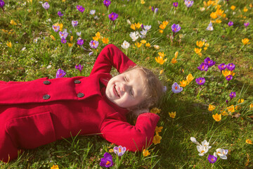 The kid smiles and enjoys the spring weather.