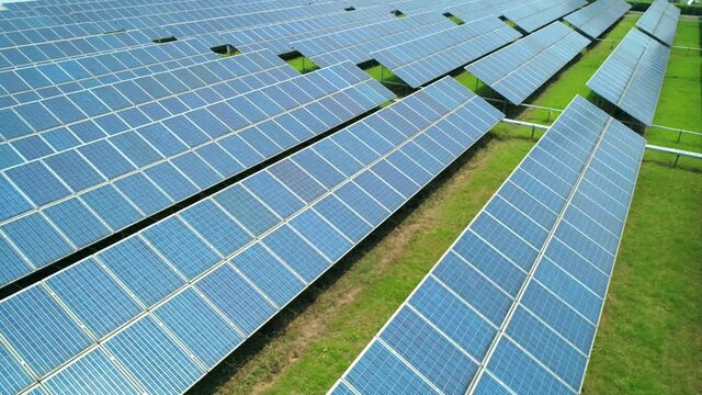 Aerial view of Solar Panels Farm (solar cell) with sunlight. Production of clean energy. Renewable green alternative energy concept.