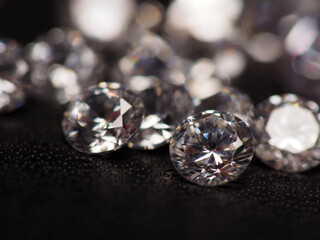 Close up shoot of group of sparkling diamonds, shoot on black leather as background