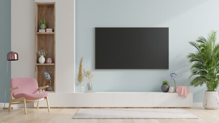 Smart TV on the blue wall in living room with armchair,minimal design.