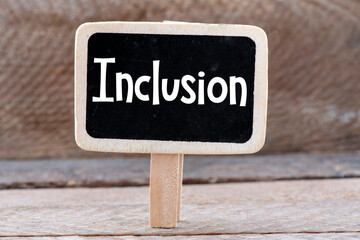 The word Inclusion written on a small chalkboard.