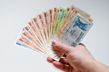 Man holds multi-colored bills. Banknotes of the Republic of Moldova.
