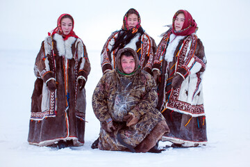 Yamalo-Nenets Autonomous Okrug, extreme north, Nenets family in the national winter clothes of the northern inhabitants of the tundra, the Arctic circle - obrazy, fototapety, plakaty