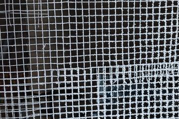 iron mesh covered with frost on a black background