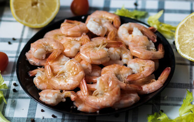 
Ready shrimps are on a black plate