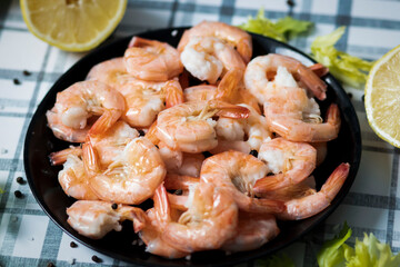 
Ready shrimps are on a black plate
