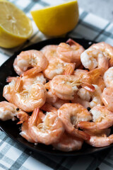 
Ready shrimps are on a black plate