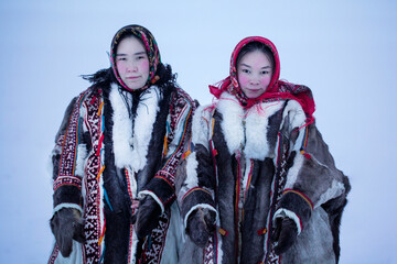 Yamalo-Nenets Autonomous Okrug, extreme north, Nenets family in the national winter clothes of the northern inhabitants of the tundra, the Arctic circle - obrazy, fototapety, plakaty