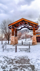 Pavilion with steps against snowy mountain and cloudy sky background in winter