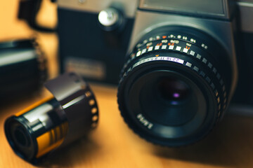 Fototapeta na wymiar Close up shot of an analog camera on a wooden background.