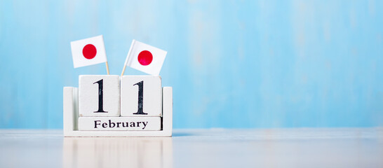 Wooden calendar of February 11th with miniature Japan flags. National Foundation Day,  New Year's Day in the traditional lunisolar calendar, public Nation holiday Day and happy celebration