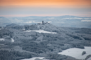 Breathtaking view from the highest mountain in the Eifel to the Nürburg in winter