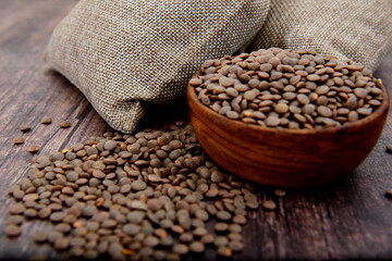 Organic brown Lentils in a wooden bowl