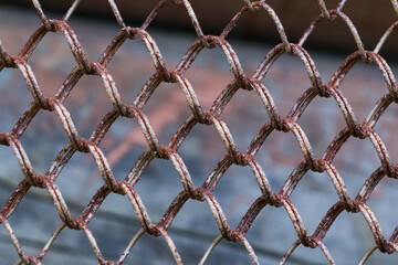 Fototapeta premium Metal rusty security fence on blurred background