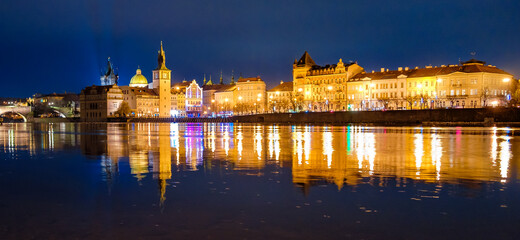 Fototapeta premium Panoramic view on Karlovy Lazne, Museum of Bendrich Smetana with reflection in Vltava River, Prague, Czech Republic