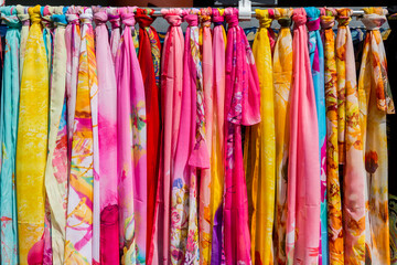Colorful Silk scarves hanging in market for sale in the gift shops of New Yuanming Palace, Zhuhai, China