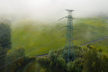 Aerial view of the high voltage power lines and high voltage electric transmission on the terrain...