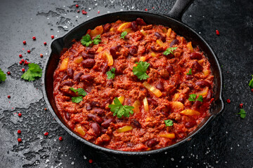 Vegetarian vegan mince chili con carne served in cast iron skillet pan