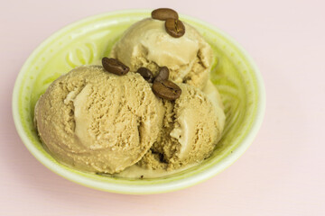 fresh coffee ice cream scoops in a bowl with coffee beans