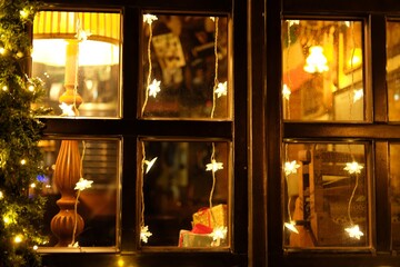 restaurant window decorated for christmas at night