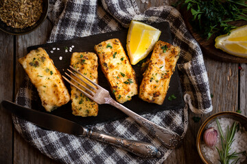 Cooked fish fillet with lemon and vegetables