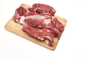 Fresh raw lamb meat on a wooden cutting board, close-up