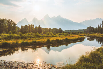 Schwabacher landing in Grand Teton National Park at dusk when sun is setting and is low over the mountain range profile. Wyoming, USA