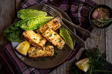 Cooked fish fillet with lemon and vegetables