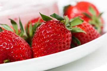fresh strawberry and a jar of yogurt