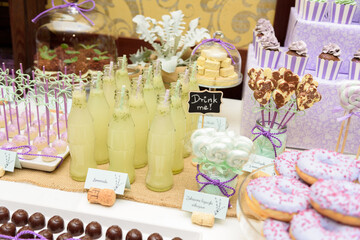 Fresh lemonade and some tasty sweets on a rustic wedding candy bar