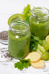 green fruit and vegetable smoothies in jars, vertical top view