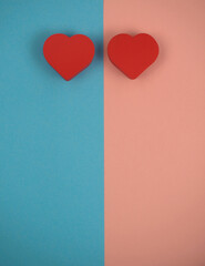 two red hearts on blue and pink background