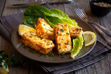 Cooked fish fillet with lemon and vegetables
