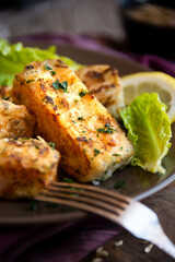 Cooked fish fillet with lemon and vegetables