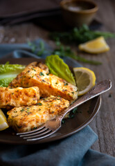 Cooked fish fillet with lemon and vegetables