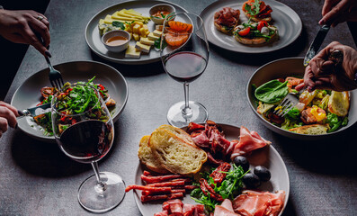 two woman eating healthy salad from bowl sitting in cafe
