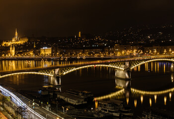 Fototapeta na wymiar Beautiful panoram in the city at night with illuminated bridge across the river in the heart of the city