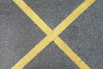Old yellow lines on a cement floor in the parking lot , which ideal for use in the background design  put images and insert text