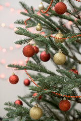 Part of Christmas tree decorated in red and gold