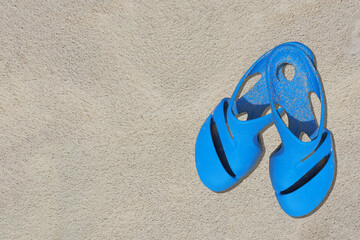 Sandals azure old condition and dirty with sand is  on beach sand sandy background