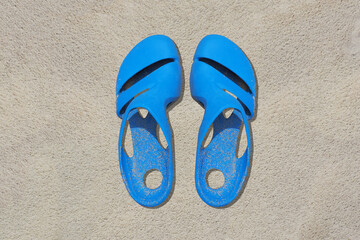 Sandals azure old condition and dirty with sand is  on beach sand sandy background