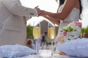 bride and groom holding champagne glasses