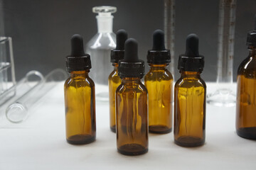 amber bottle with droppers or dropping bottles. Scientific laboratory glassware.