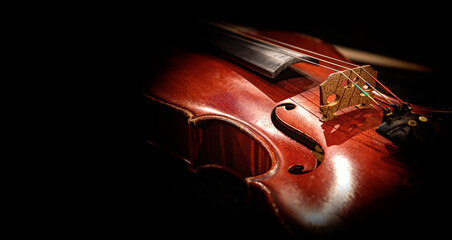 Violin on a dark background. An old violin in beautiful lighting.