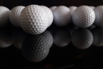 Golf balls and golf clubs to dark Background