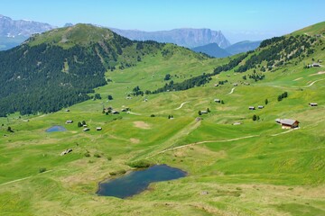 Fototapeta na wymiar Beautiful summer mountain scenery with rural barns , Seceda , Dolomites Italy, European Alps.