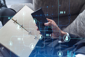 Hands of hr specialist browsing social networks in the Internet in smart phone to find the best...