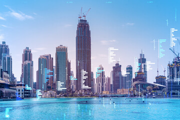 Fototapeta na wymiar Skyscrapers of Dubai business downtown. International hub of trading and financial services of Western Asia. FOREX graph and chart concept. Double exposure. Dubai Canal waterfront.