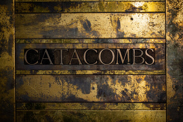 Catacombs text on vintage textured bronze grunge copper and gold background